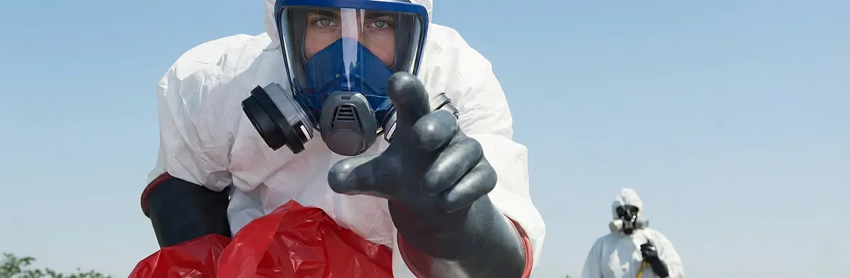 sewage clean up technician wearing protective gear handling biohazard materials in Wichita, KS